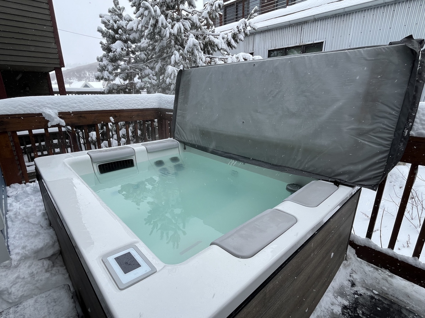 Unwind in this serene winter oasis featuring a private, steaming hot tub on a snowy deck. Perfect for après-ski relaxation, this cozy retreat offers the ultimate seasonal escape.