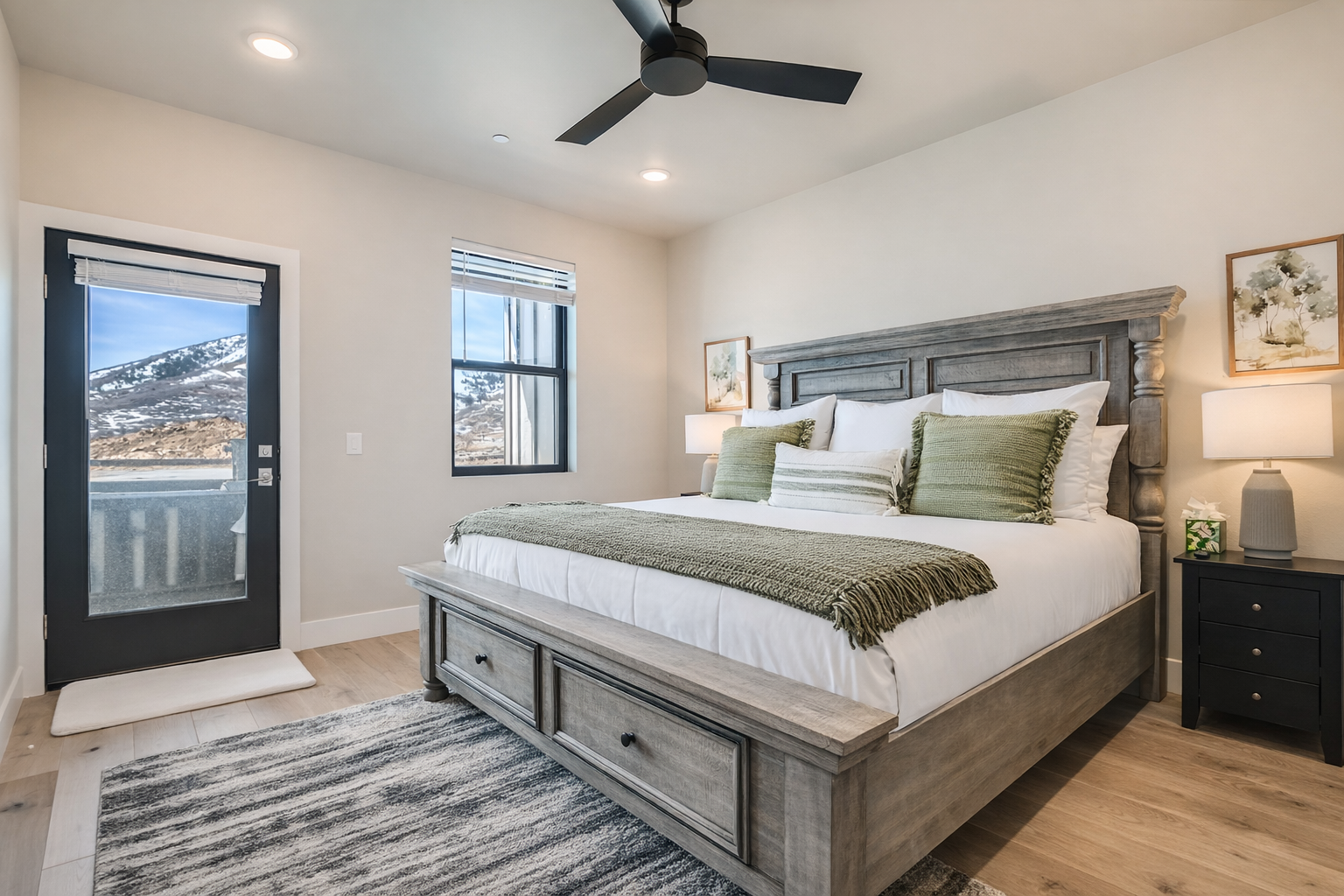 Relax in this bright, modern bedroom featuring a plush king bed and sleek wooden accents. A serene mountain retreat with large windows—perfect for your next Park City adventure.