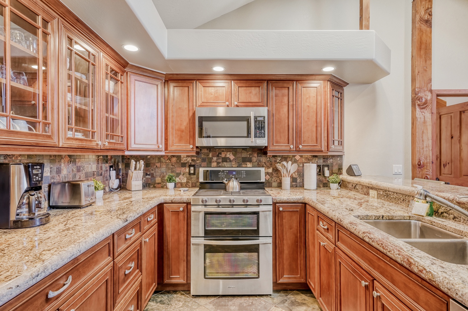 Your gourmet kitchen awaits with granite counters, rich cherry cabinets, and premium appliances ready for culinary adventures.
