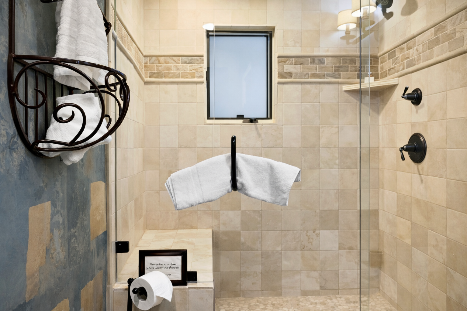 Step into your beautifully tiled bathroom with luxurious walk-in shower, elegant stone details, and fresh towels awaiting your arrival.