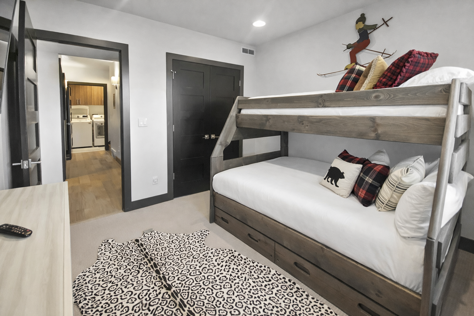 Cozy bunk beds with rustic wood frames create the perfect mountain retreat for your group, complete with ski-themed decor.