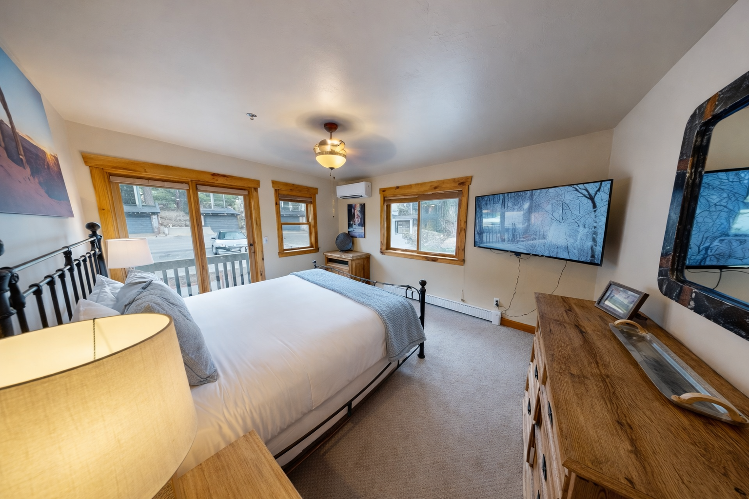 Cozy mountain retreat with a plush king bed and TV. Step onto the private deck with forest views.