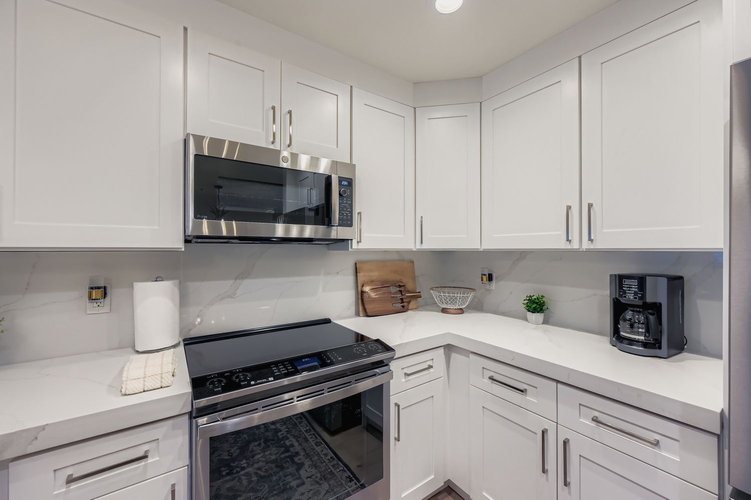 Your fully equipped kitchen features modern appliances and elegant white cabinetry, perfect for preparing meals during your stay.