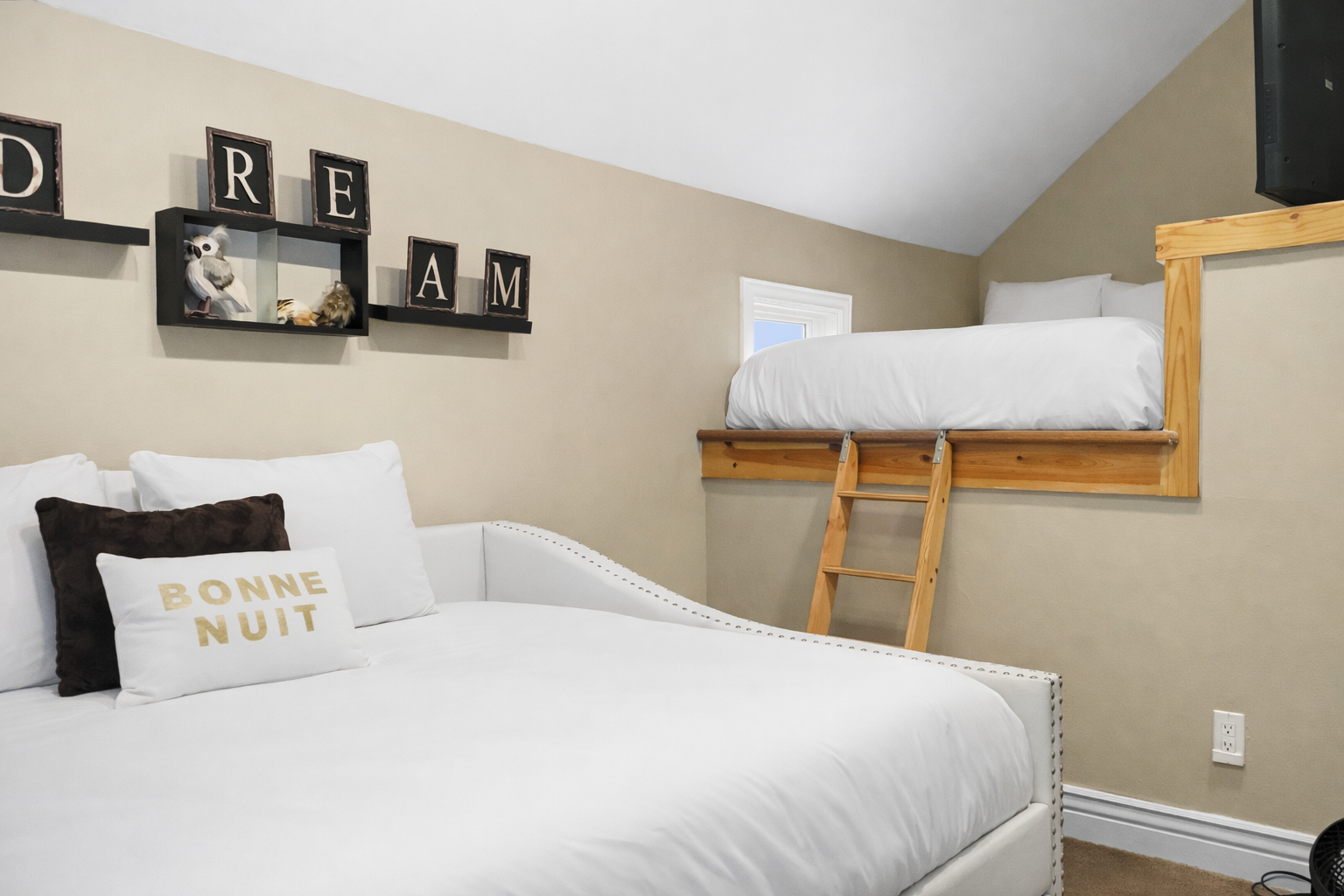 Sleep soundly in this unique bunk/daybed room, featuring a cozy lower bed and a fun upper loft bed with ladder access.