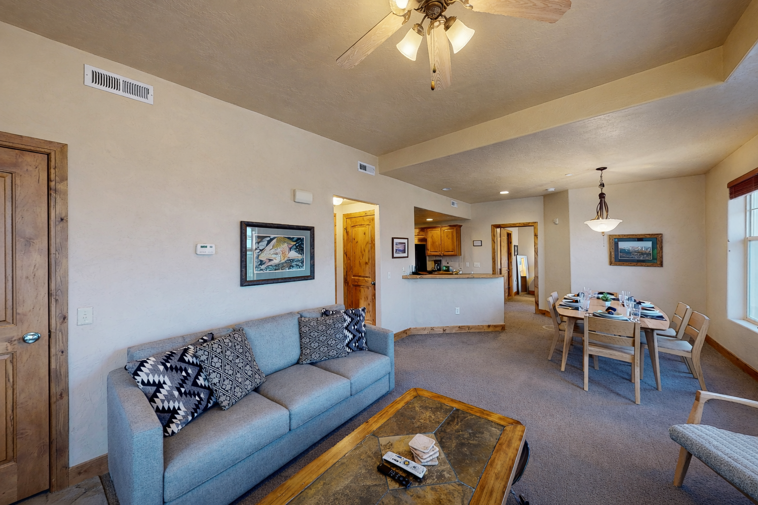 Relax in your spacious open-plan living area with comfortable seating, dining space, and kitchen—perfect for unwinding after mountain adventures.