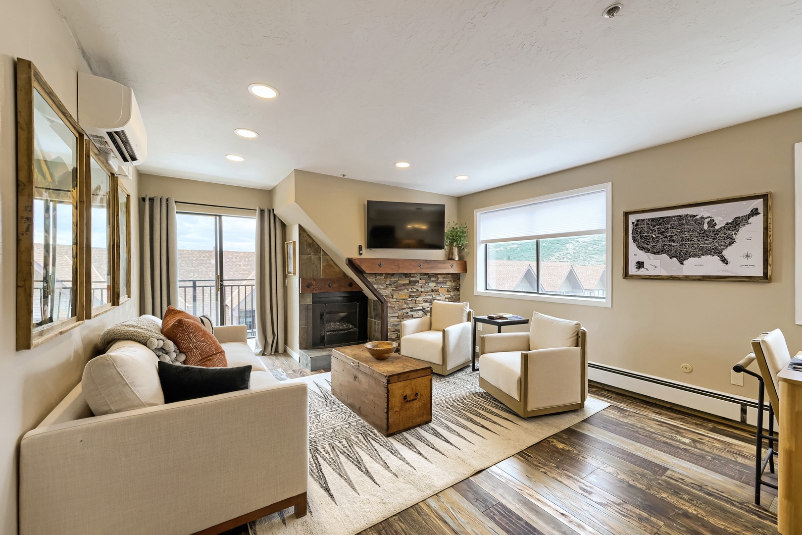 Settle into your inviting living space where a cozy fireplace and mountain views create the perfect retreat after a day of adventure.