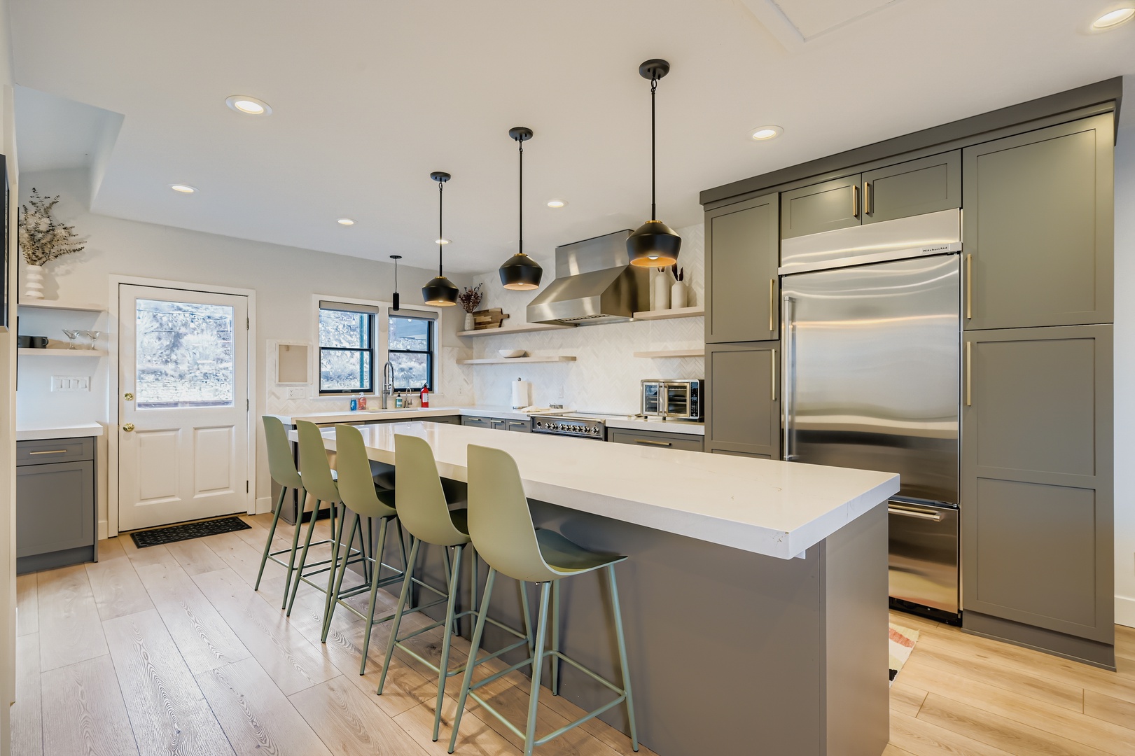 Step into your gourmet kitchen where culinary dreams come alive! This stunning space features gleaming stainless steel appliances, elegant pendant lighting, and a spacious island.