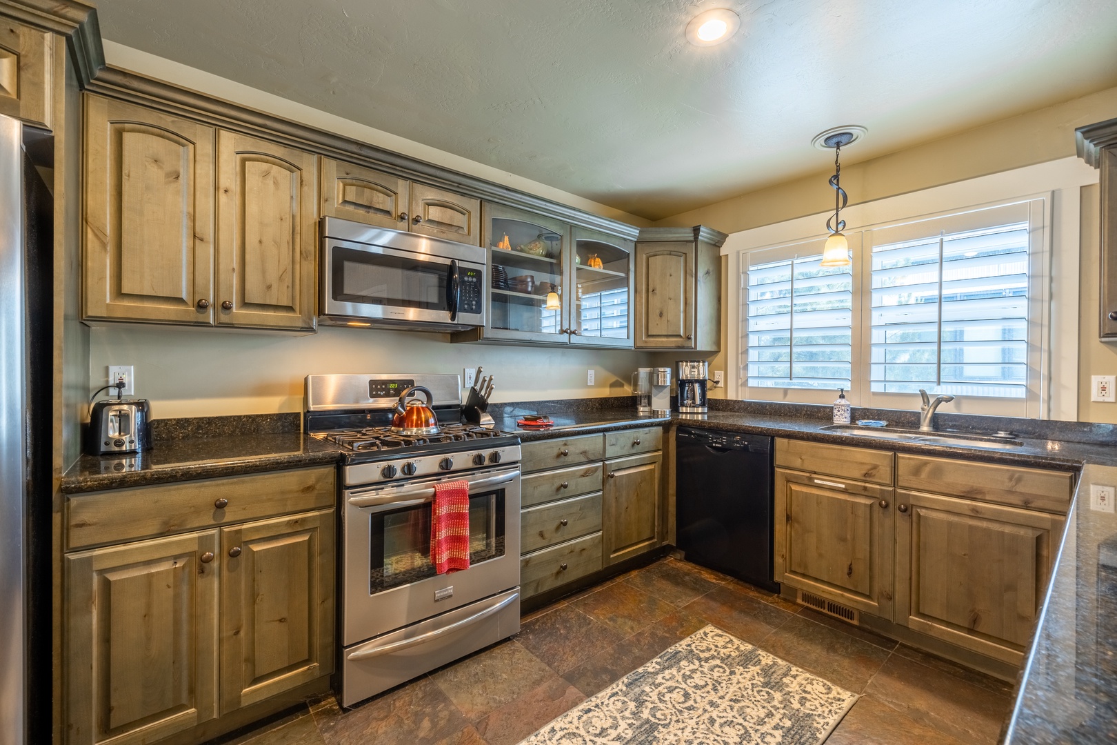 Step into your fully equipped kitchen with stainless steel appliances, granite countertops, and ample cabinet space—perfect for preparing your favorite meals during your stay.
