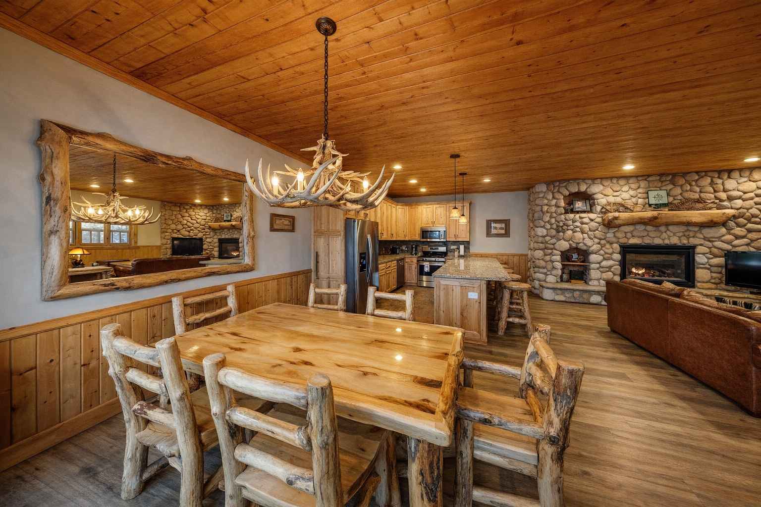 Gather around your rustic dining table beneath the antler chandelier, with the stone fireplace crackling nearby as you cook in your fully equipped kitchen.
