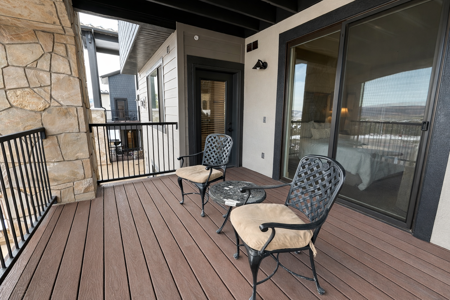 Your private balcony awaits with comfortable seating and large windows offering natural light and views of the surrounding area.