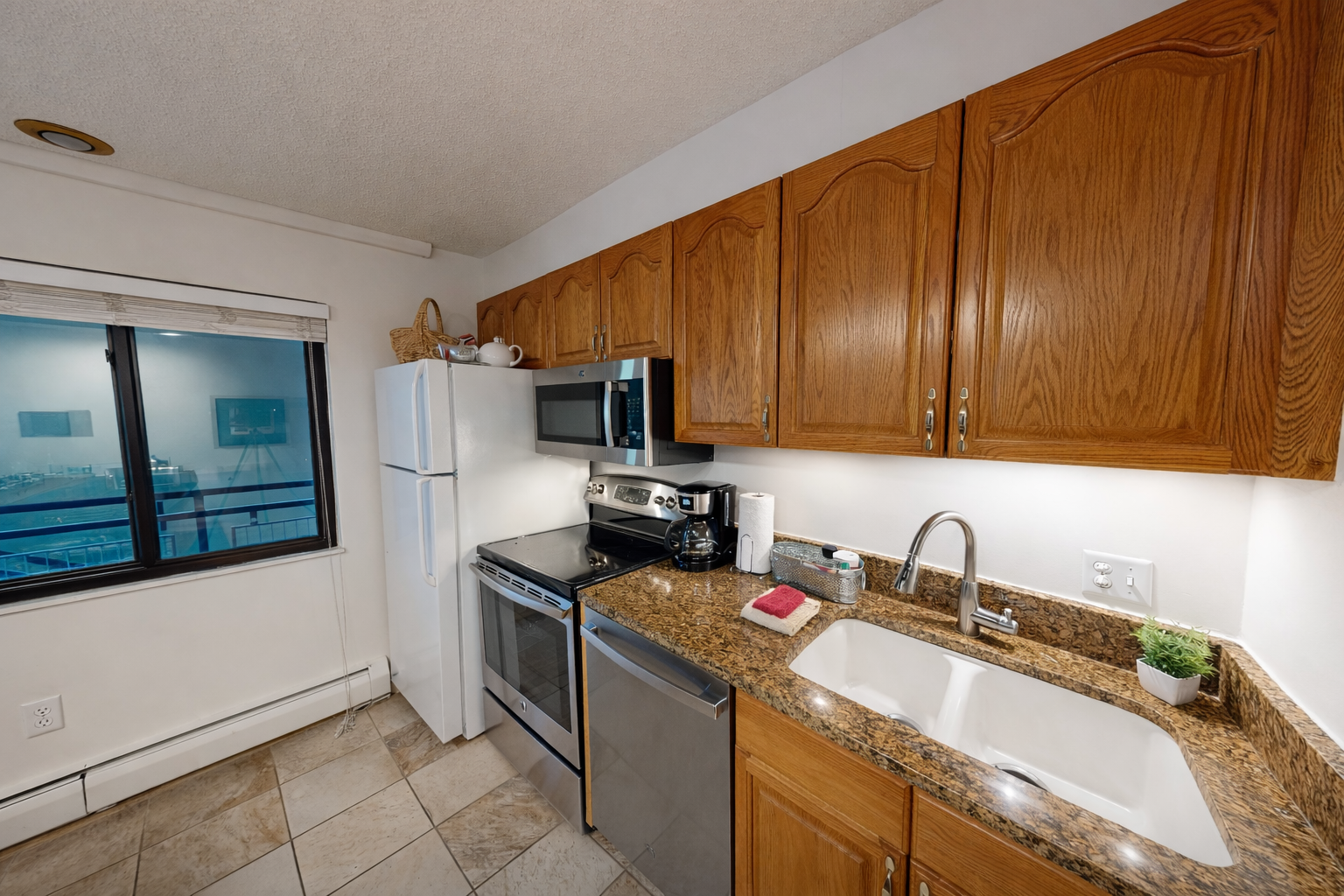 Your fully equipped kitchen awaits with granite counters, stainless appliances, and city views—perfect for preparing meals during your stay.