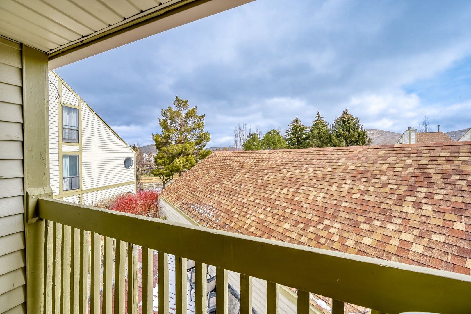 Step onto your private balcony and breathe in the fresh mountain air while taking in peaceful views of the surrounding neighborhood and distant peaks.