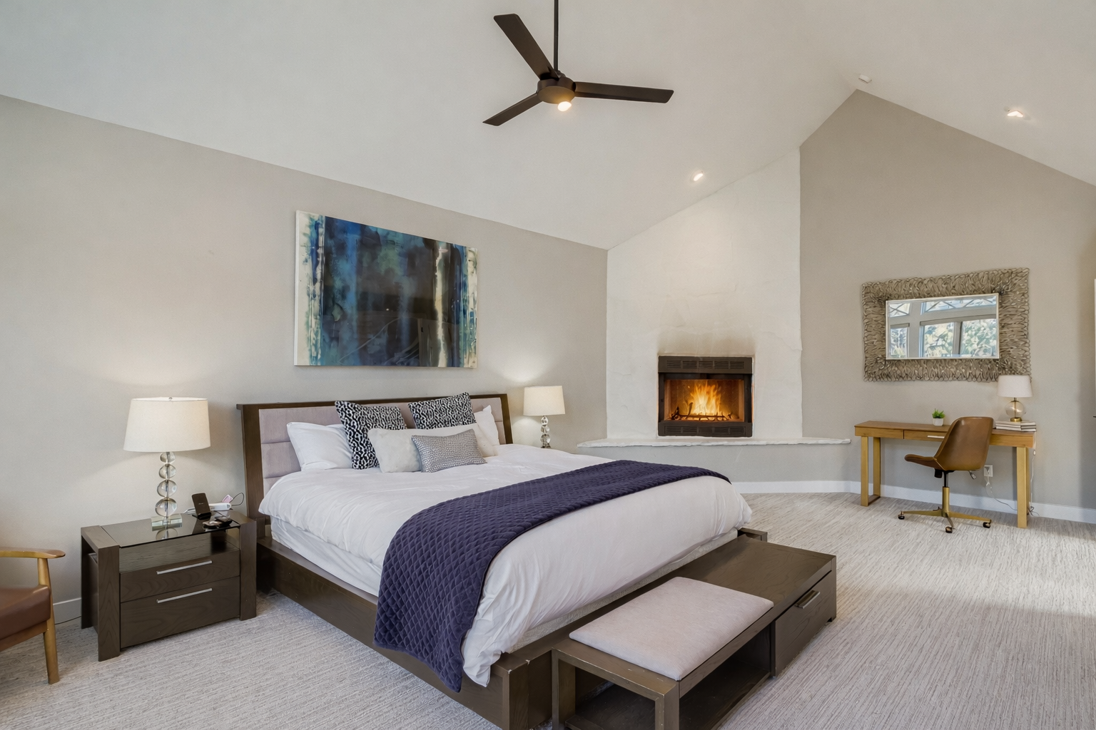 Retreat to the primary suite with a plush king bed, vaulted ceilings, and large windows offering scenic views. Enjoy the TV after a day in Park City.