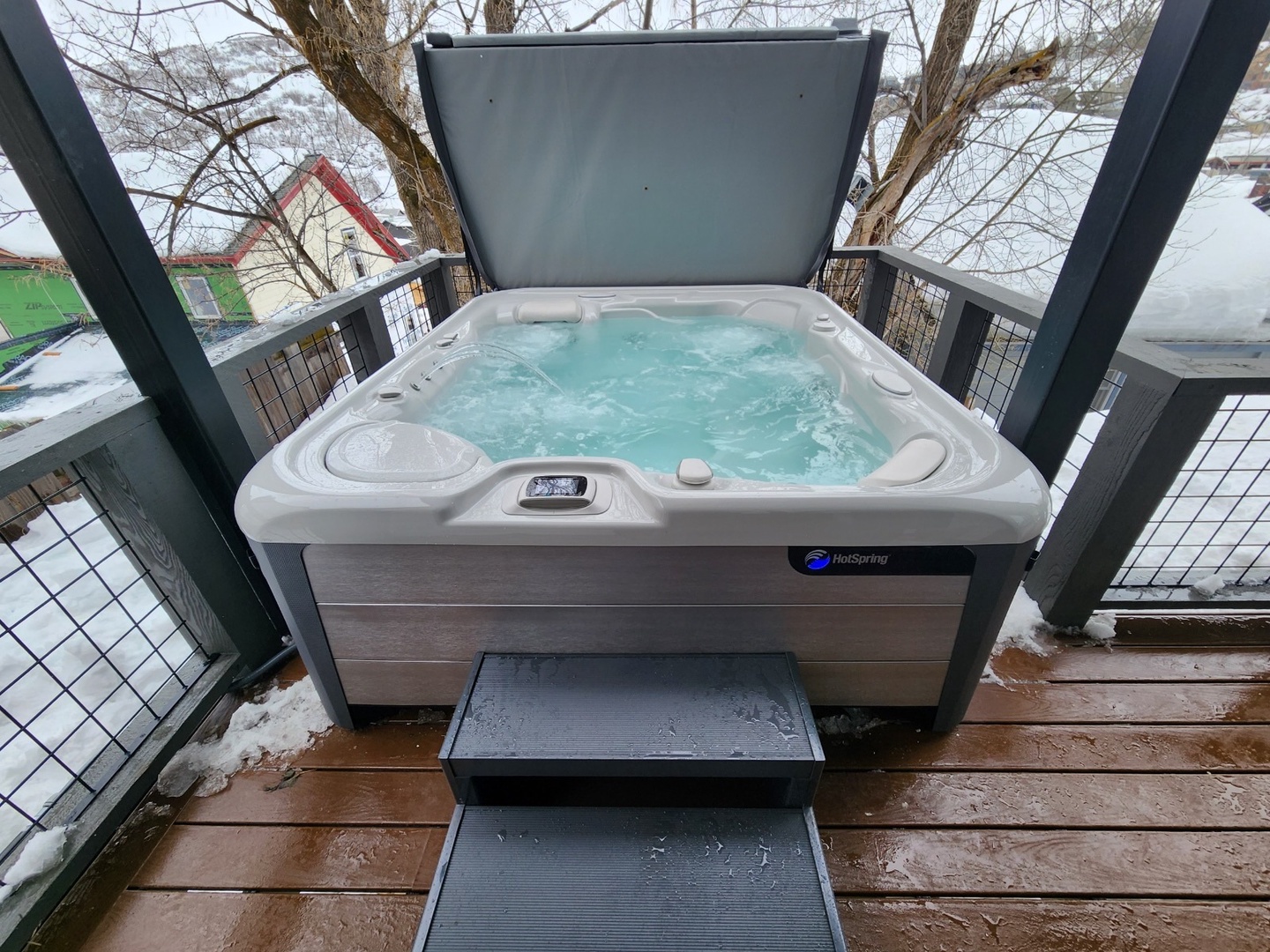 Soak away winter's chill in your private hot tub, where warm bubbles and snowy views create the perfect retreat.