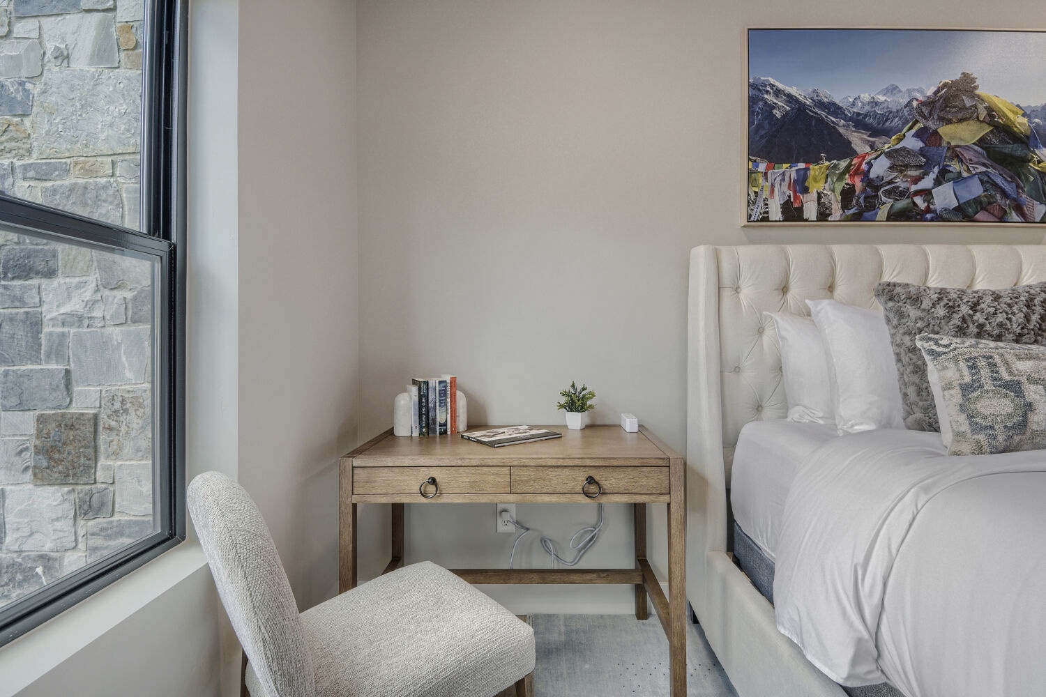 Sink into plush linens and wake to serene mountain views—your peaceful retreat awaits in this bright, elegantly appointed bedroom.