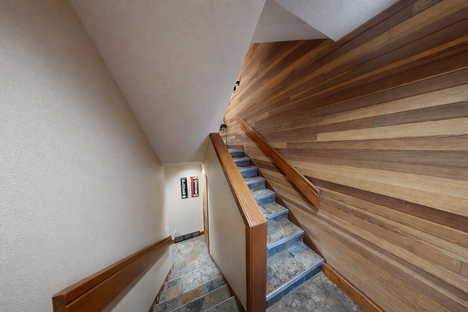 You'll love the beautiful wooden staircase with warm timber tones and modern stone steps, creating an elegant pathway to your upper-level retreat.