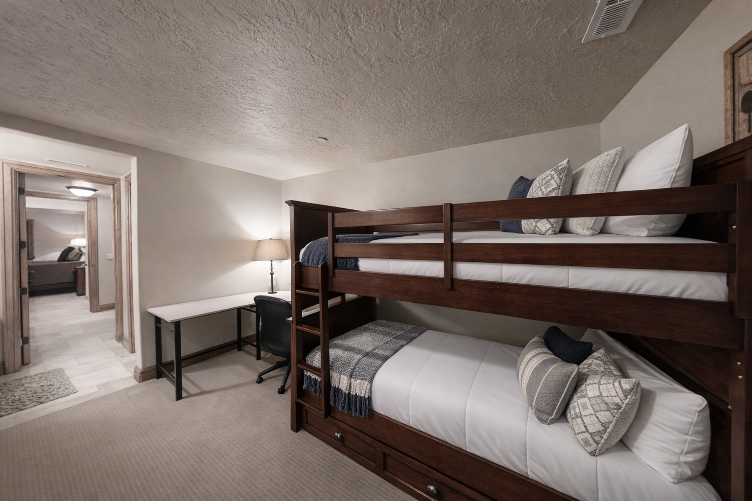 Your kids will love these sturdy bunk beds with crisp linens and cozy throws, complete with a desk for homework or games.