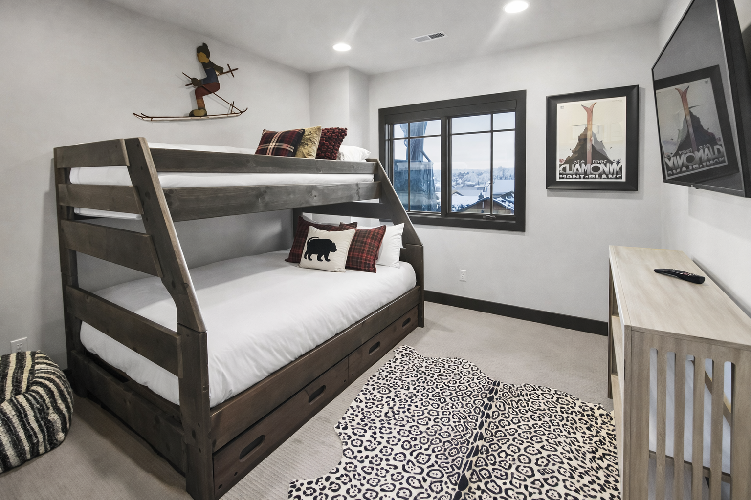 Settle into this adventure-themed bunk room where cozy beds and mountain views create the perfect retreat for your group.