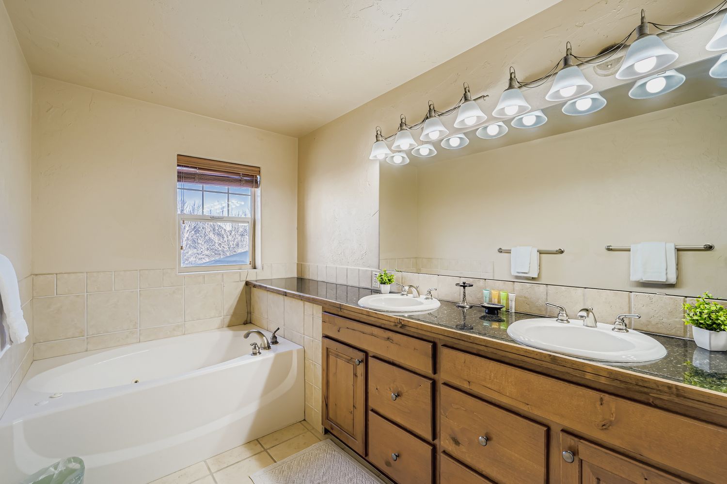 Unwind in your spacious master bathroom featuring dual vanities, a soaking tub, and abundant natural light for your daily routines.