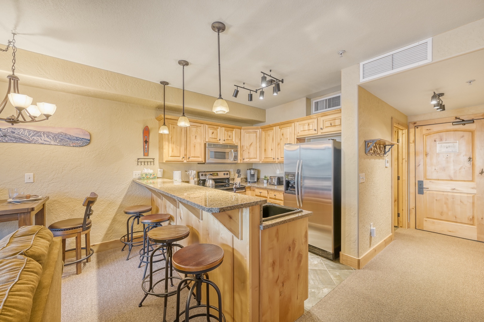 Your fully-equipped kitchen invites culinary adventures with granite countertops, stainless steel appliances, and a breakfast bar perfect for morning coffee.
