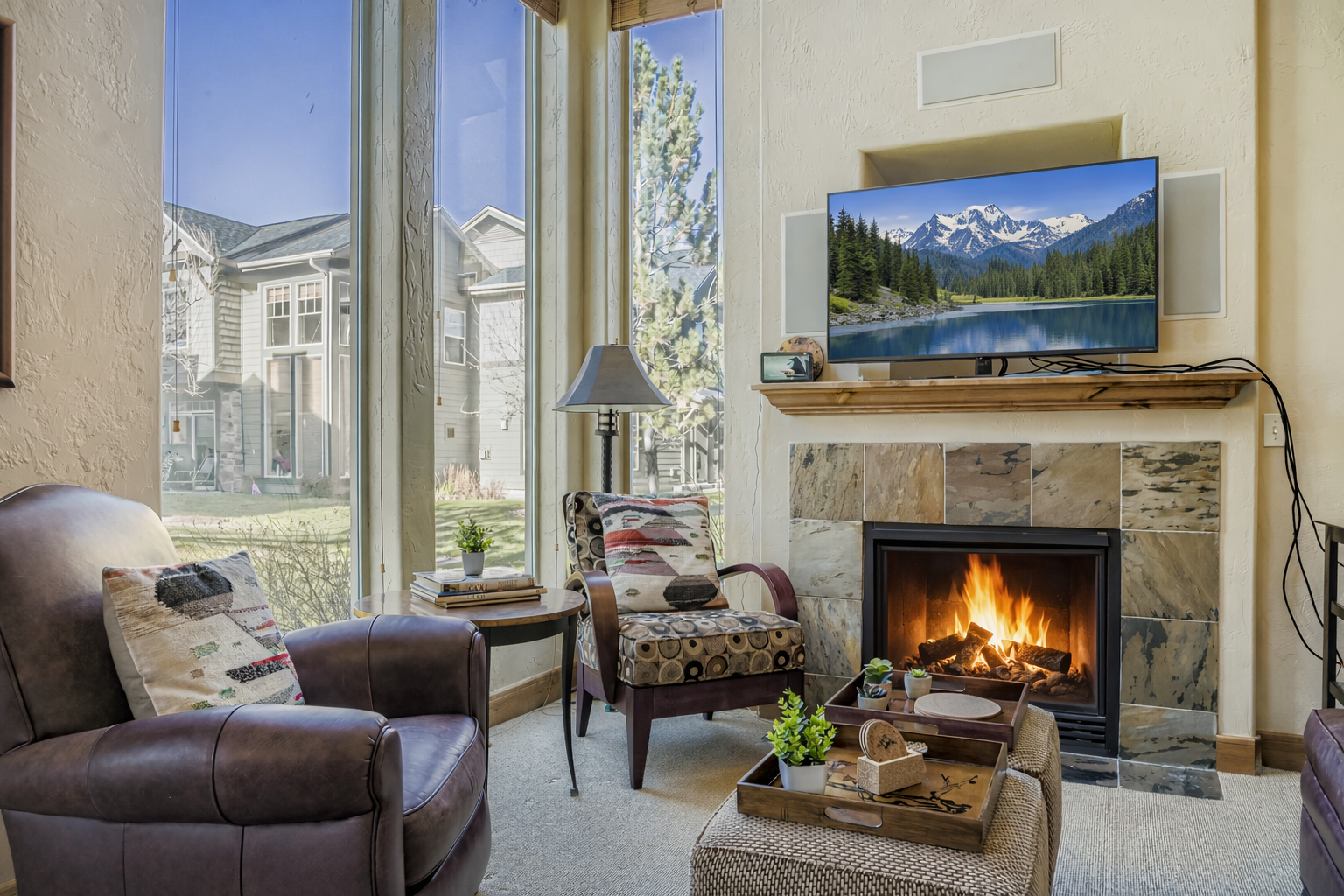 Unwind in this spacious living room with rich leather seating, a cozy fireplace, and entertainment center - your perfect home base for relaxation.
