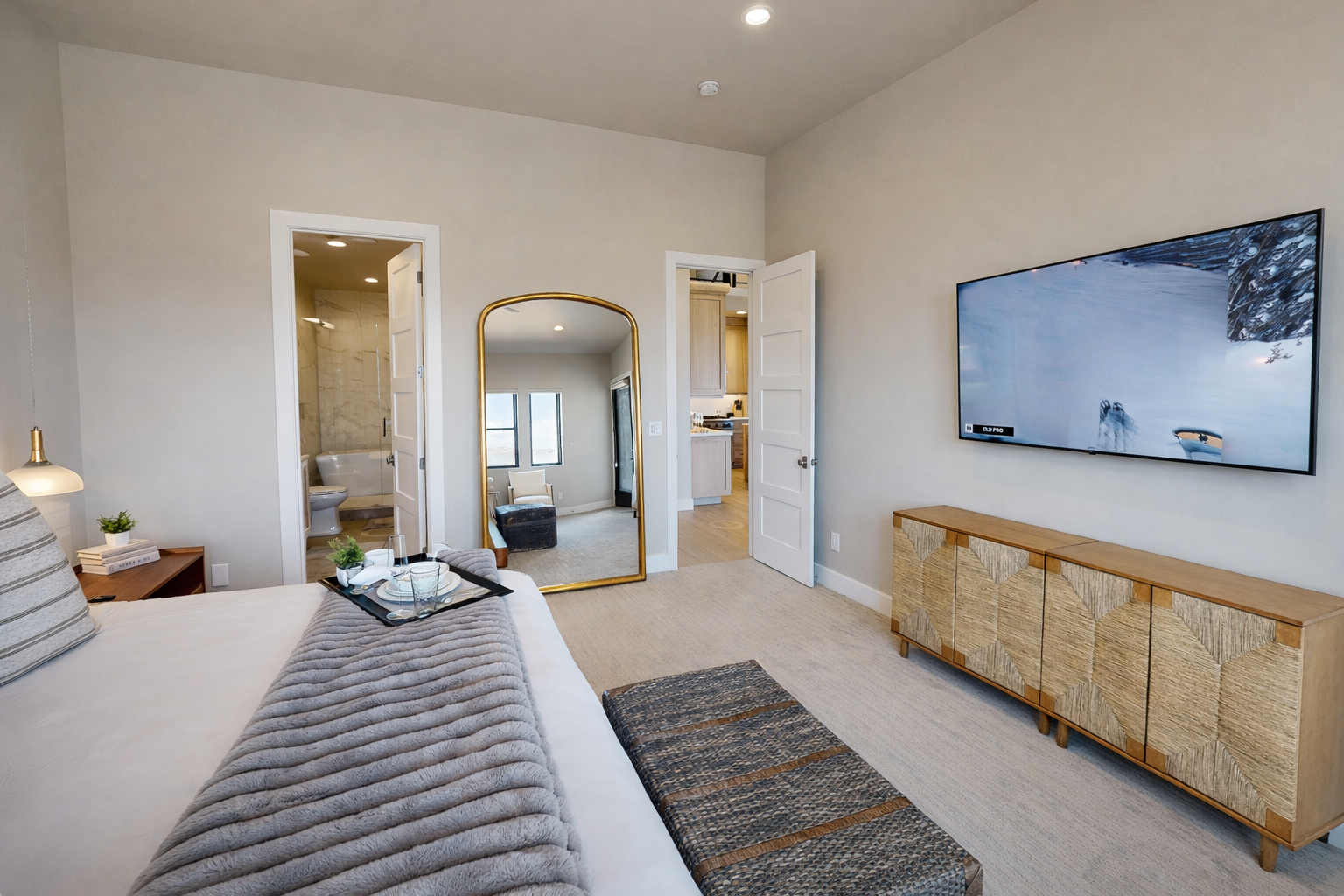 Relax in this bright, modern bedroom featuring a plush king bed, stylish decor, and cozy seating. Large windows offer stunning views, creating the perfect serene escape for your stay.