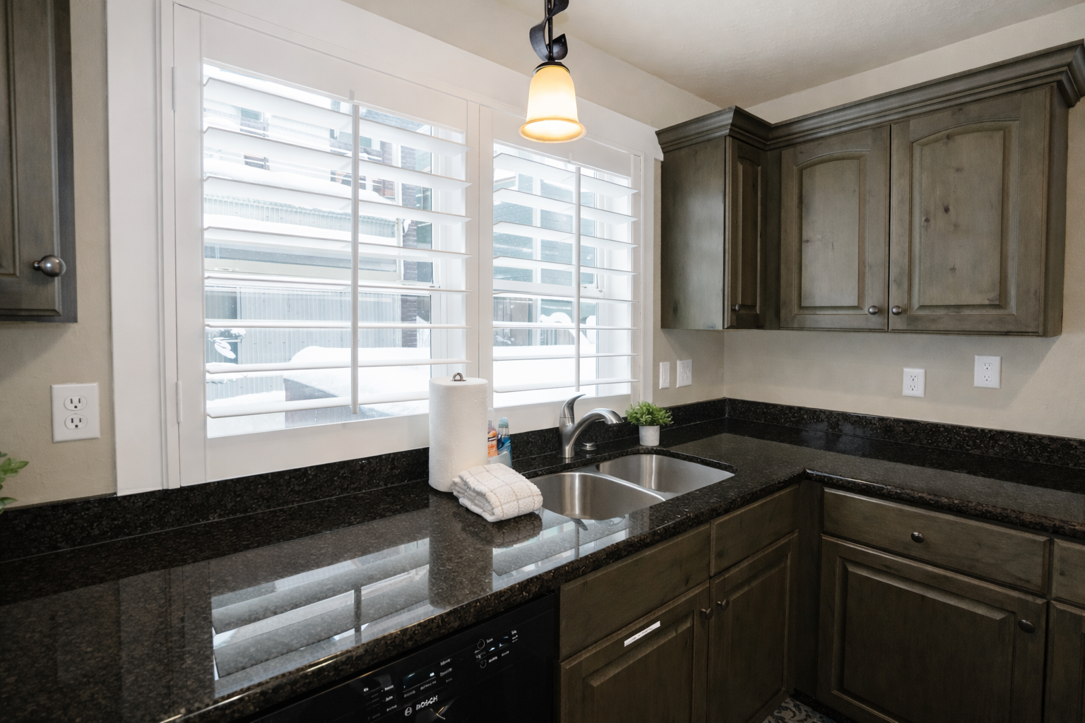 Your elegant kitchen features granite countertops and modern appliances, with bright city views creating the perfect space for culinary adventures.