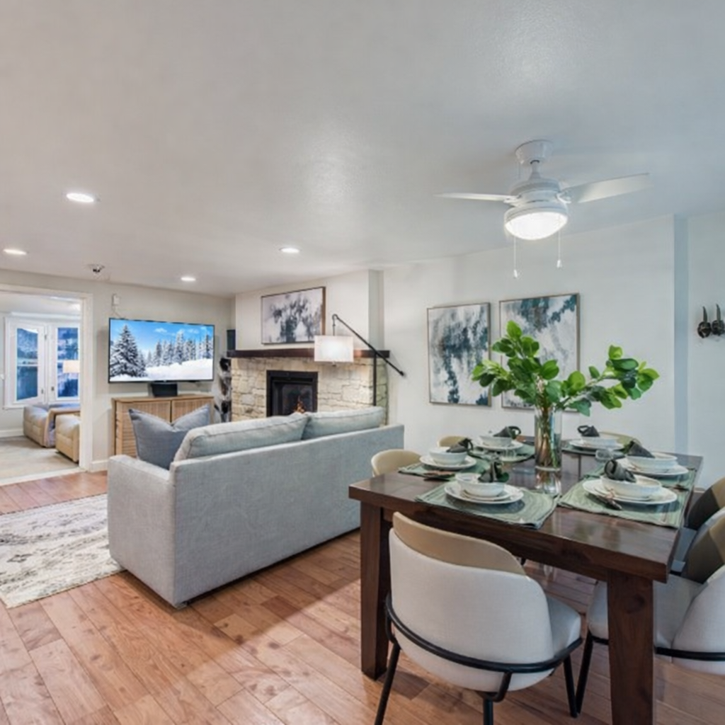 Unwind in your modern living space with cozy seating, dining for six, and a stone fireplace creating the perfect atmosphere.