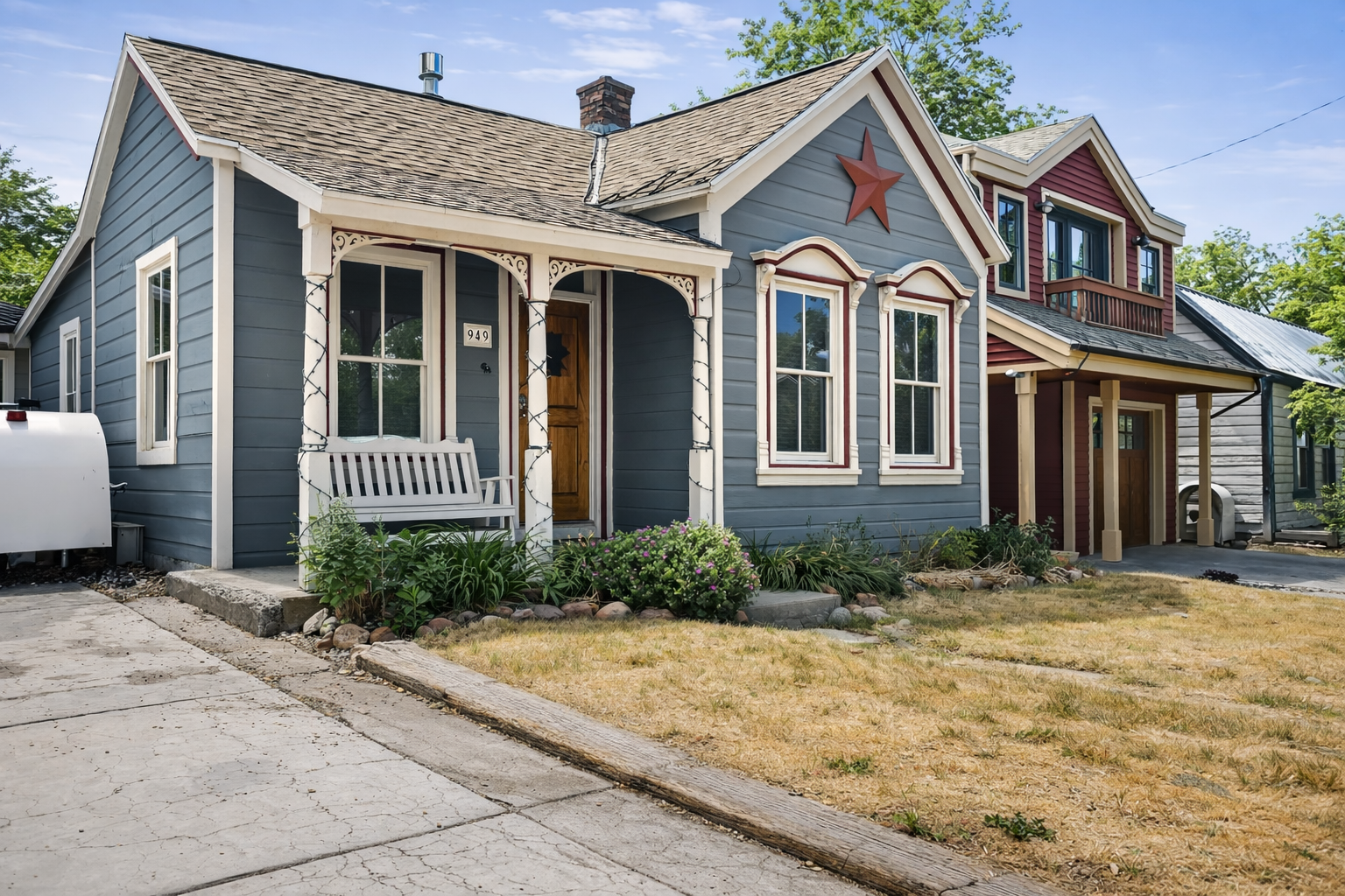 Charming character home featuring classic architecture with decorative trim and a welcoming front porch bench in a quiet residential neighborhood.