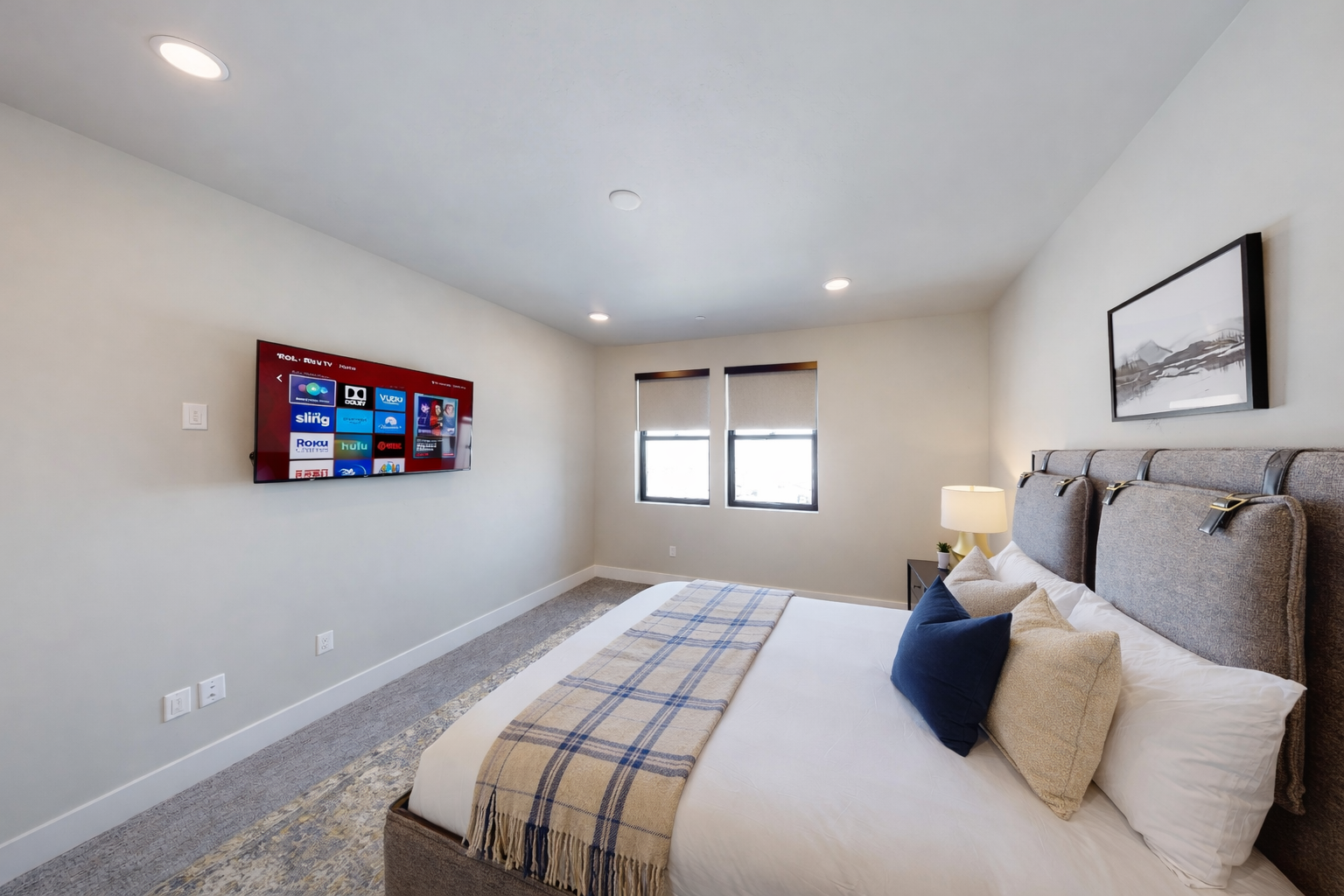 Relax in this serene, contemporary guest suite featuring a plush king-sized bed and a sophisticated upholstered headboard. With soft, neutral tones and a tranquil atmosphere, this room serves as a peaceful sanctuary for rest and recharge.