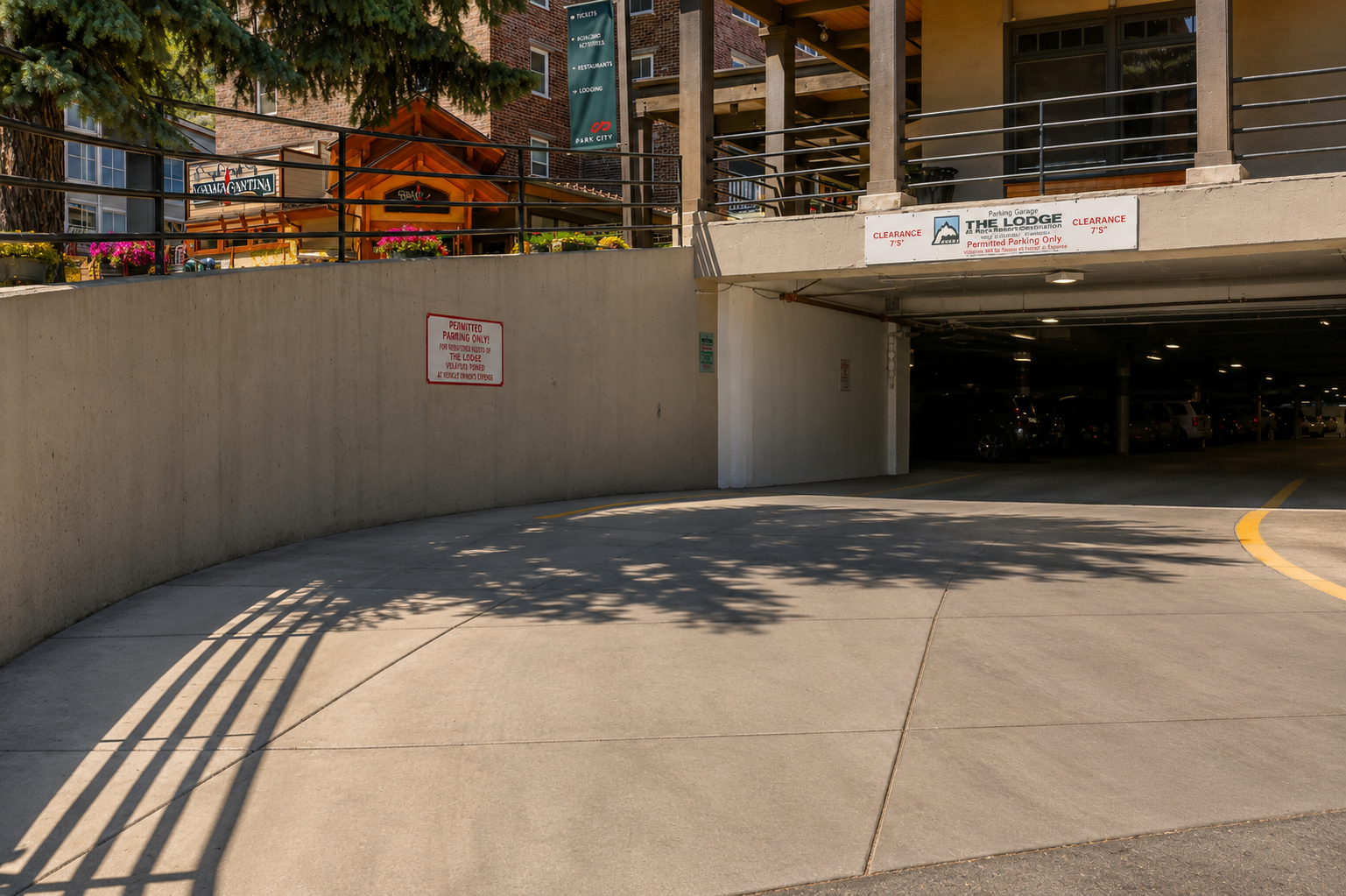 Covered parking garage entrance- provides convenient access to the property and nearby shops, with clear signage marking the entrance to The Lodge.