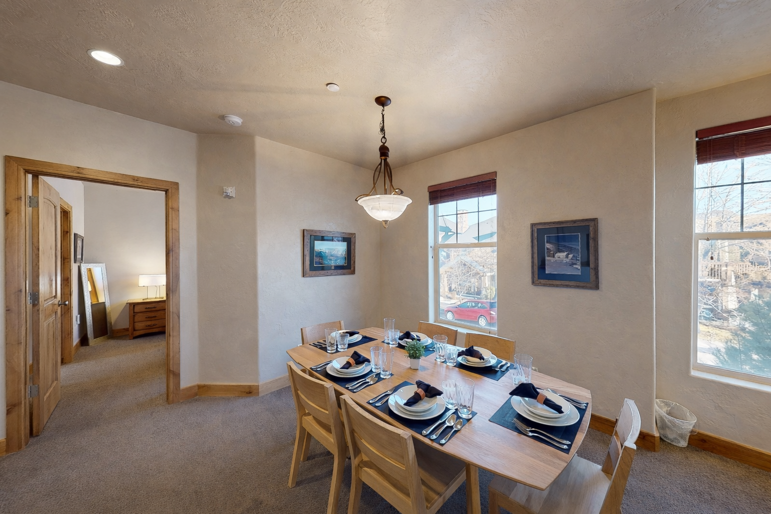 Gather around your elegant dining table for memorable meals, where warm lighting and neighborhood views create the perfect atmosphere for connection.