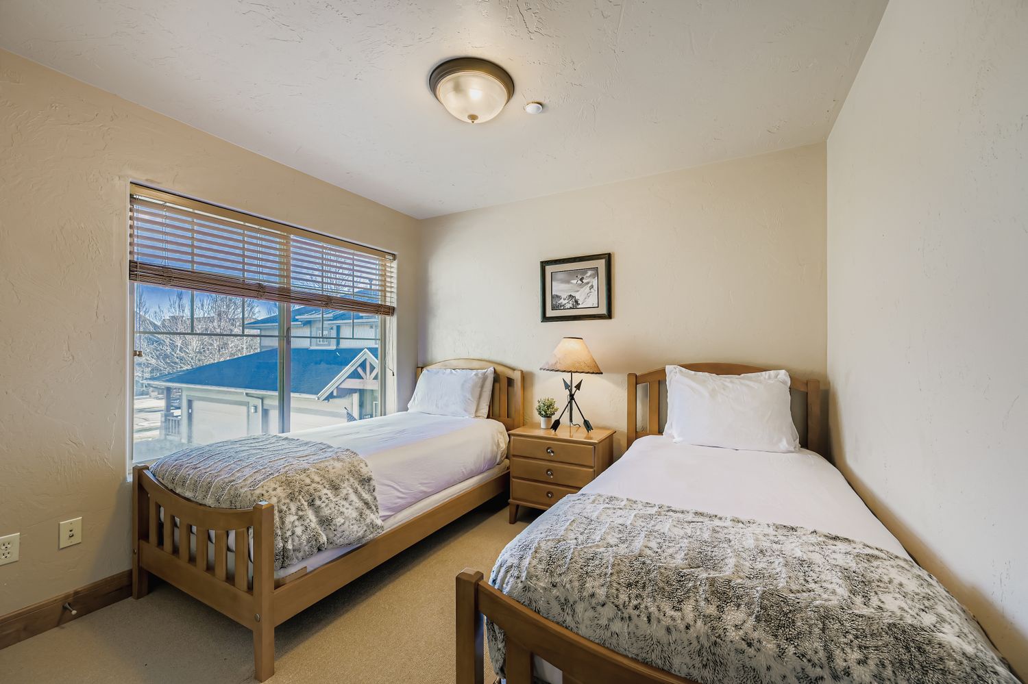Your comfortable twin bedroom features two cozy single beds with soft linens, warm lighting, and a peaceful view to help you rest after your adventures.