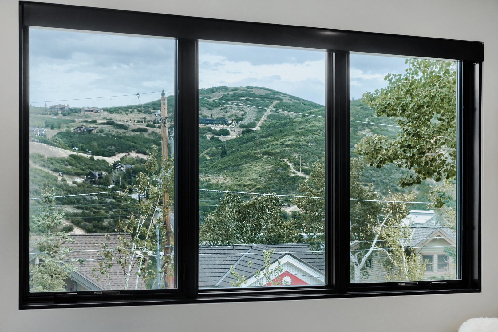 Rolling green hills and scenic mountain vistas greet you from these expansive windows, bringing the beauty of nature right into your retreat.