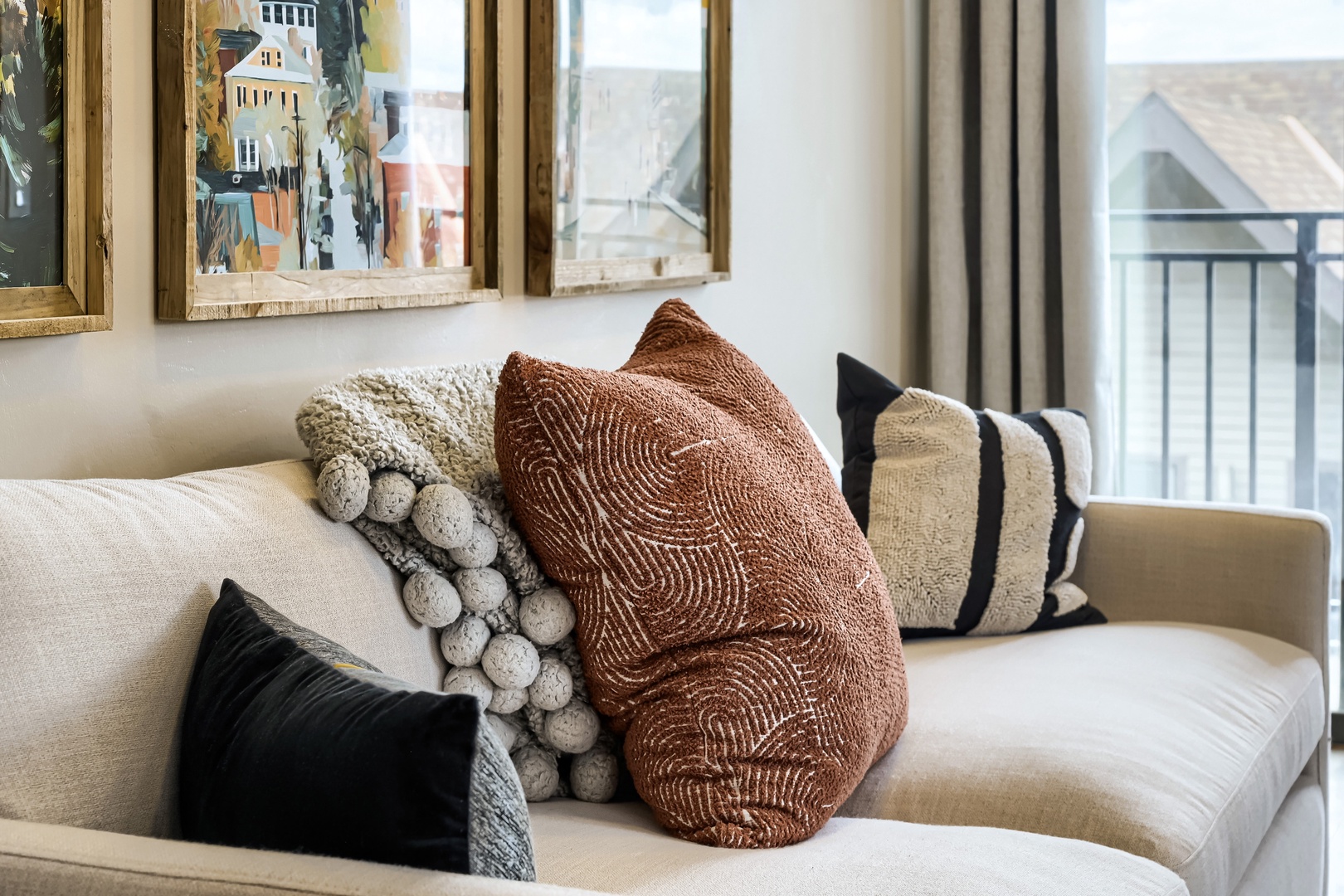 Sink into plush textures and natural light in your cozy living space, where thoughtful details invite you to unwind completely.