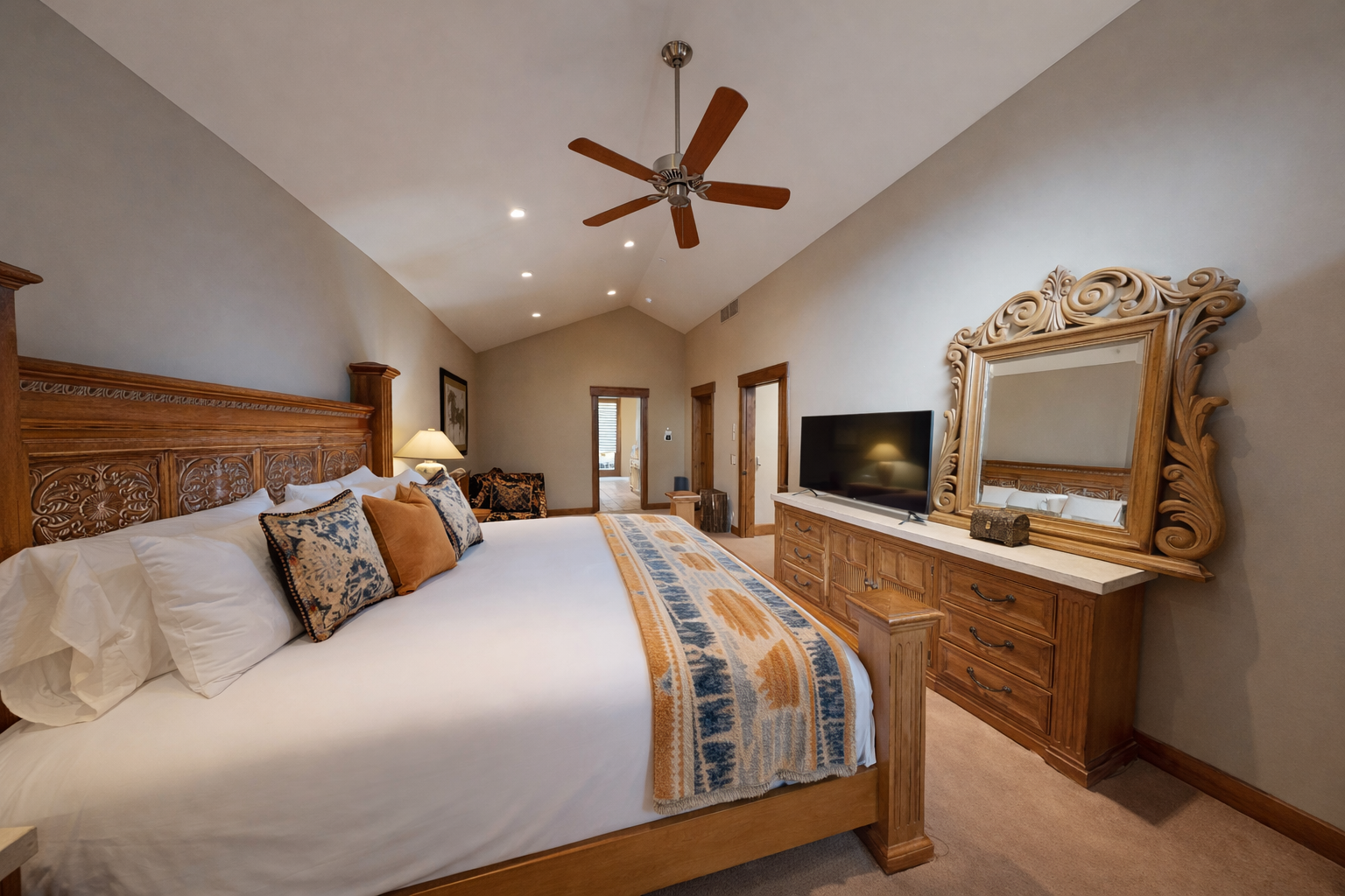 Unwind in your peaceful bedroom sanctuary with rich wood furnishings, cathedral ceilings, and soft lighting creating pure tranquility.