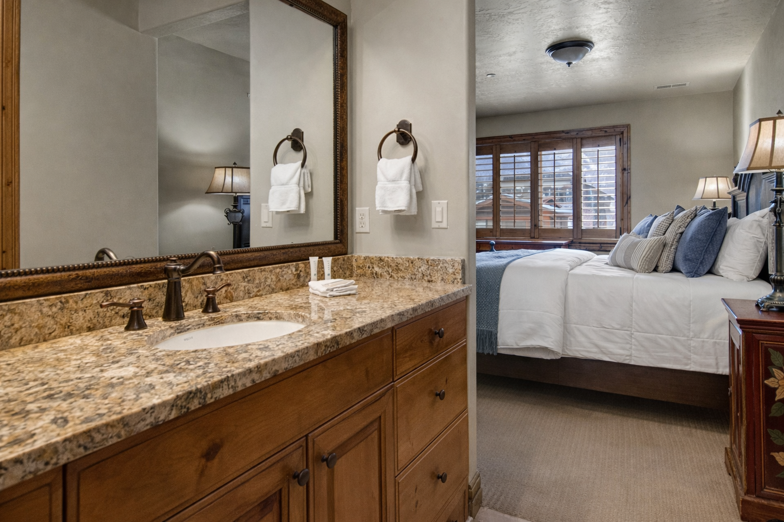 Your spacious bedroom suite features elegant granite vanity and crisp linens, perfect for unwinding after mountain adventures.