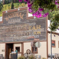 Historic property signage marks the entrance to this charming accommodation, where rustic wooden signs display room information and local character.