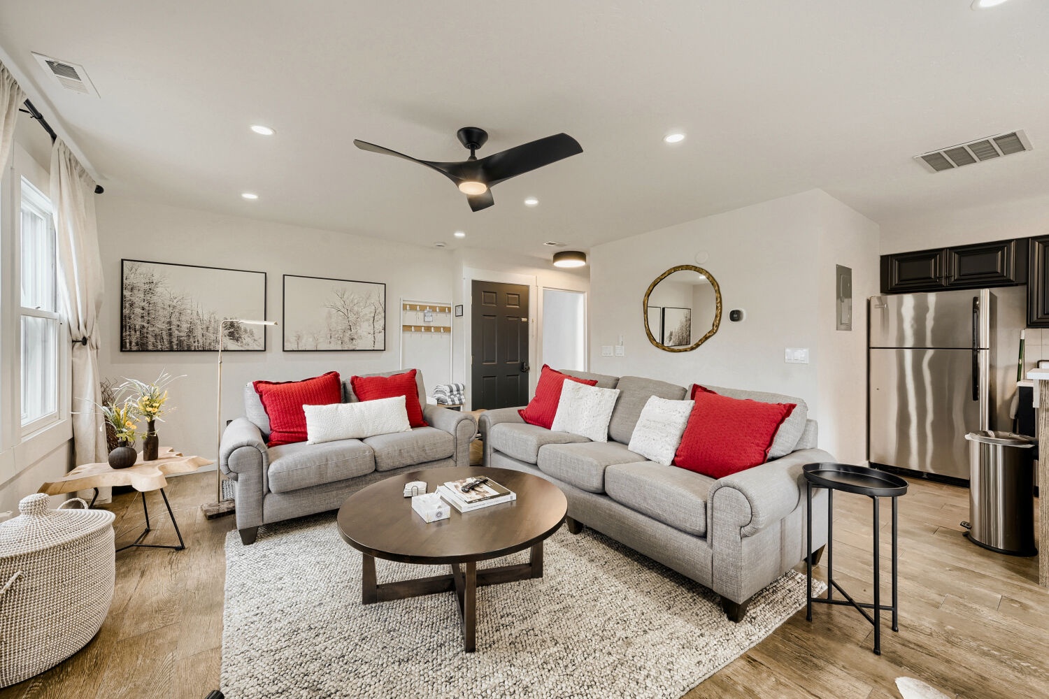 Settle into this bright, modern living space with plush seating and vibrant red accents that invite you to unwind after your adventures.
