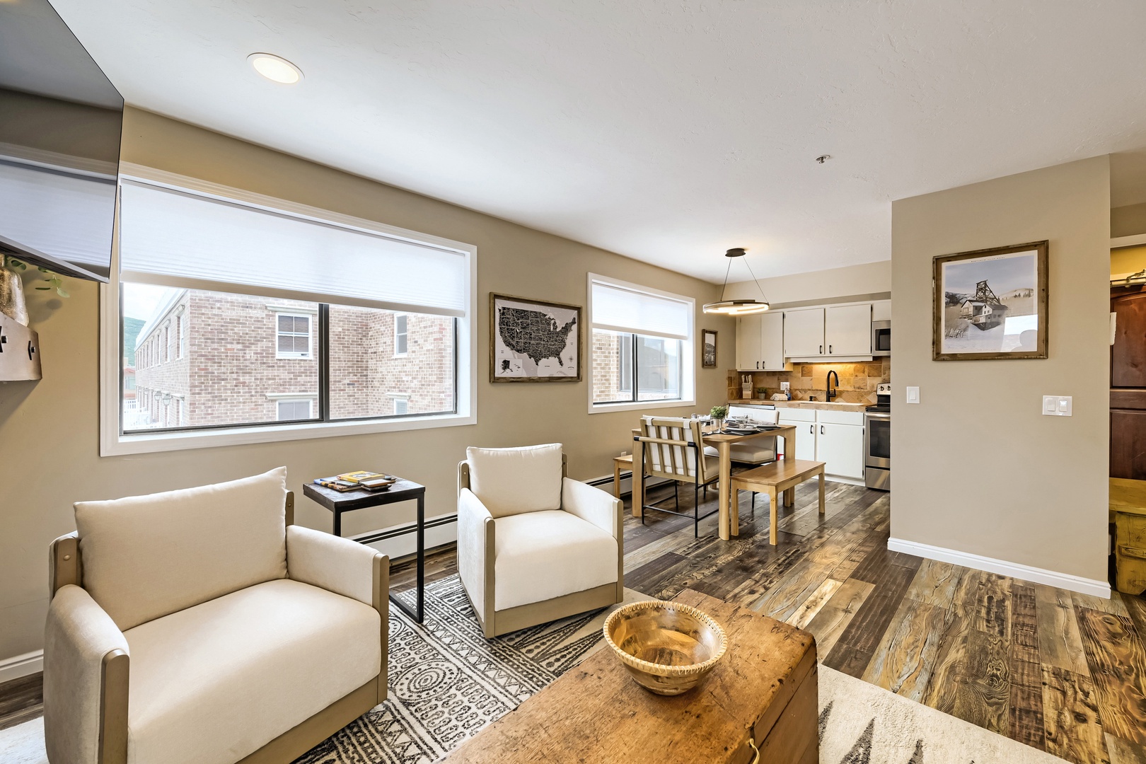 Open-plan living with natural light and modern comfort awaits. Sink into plush seating, gather at your dining table, and enjoy a fully-equipped kitchen—all framed by warm tones and charming details for your getaway.