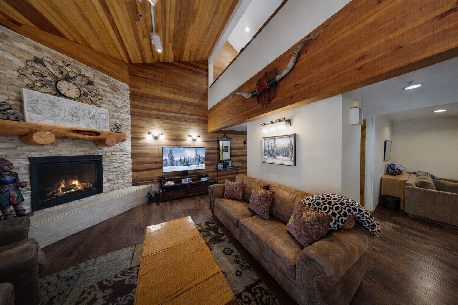 Relax by the cozy stone fireplace in this inviting living room. Enjoy the ambiance after a day exploring Park City's mountains.