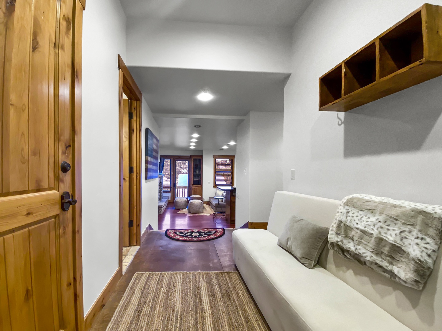 Settle into this welcoming space! Features include a cozy seating area and convenient built-in storage for your gear, ensuring a comfortable start to your stay. Unit B