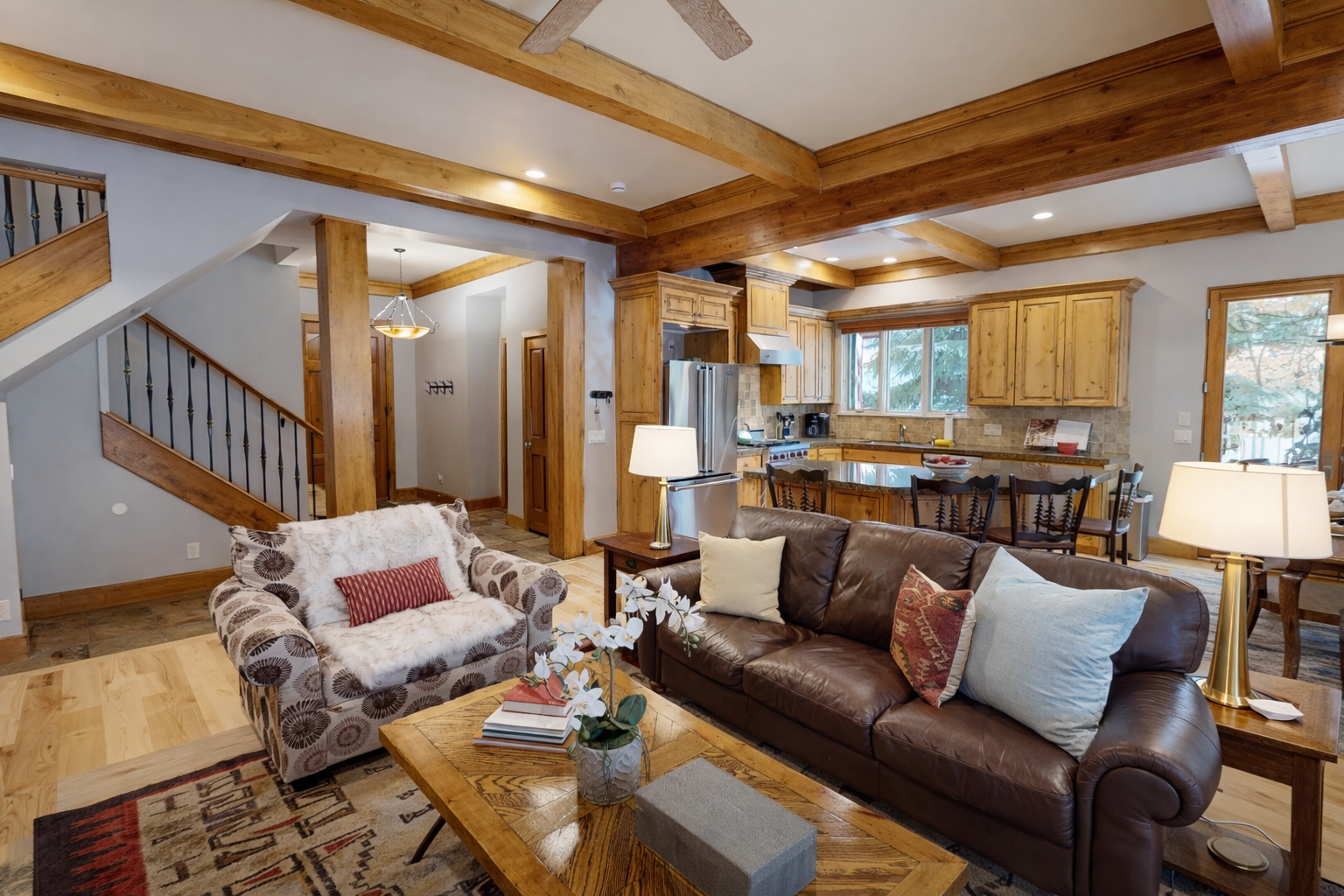 Sink into rich leather seating beneath stunning exposed beams in this warm living space that flows into your fully equipped kitchen.
