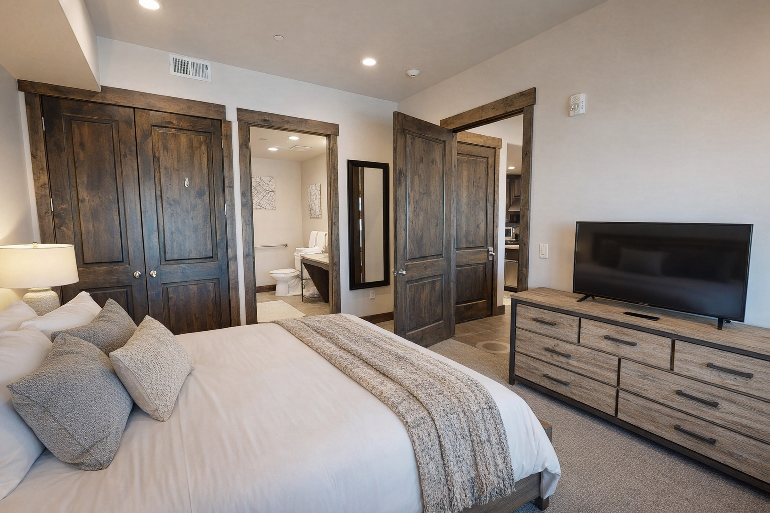 Sink into plush bedding surrounded by rich wood accents and modern amenities. Your private suite features ample storage and entertainment for ultimate comfort.