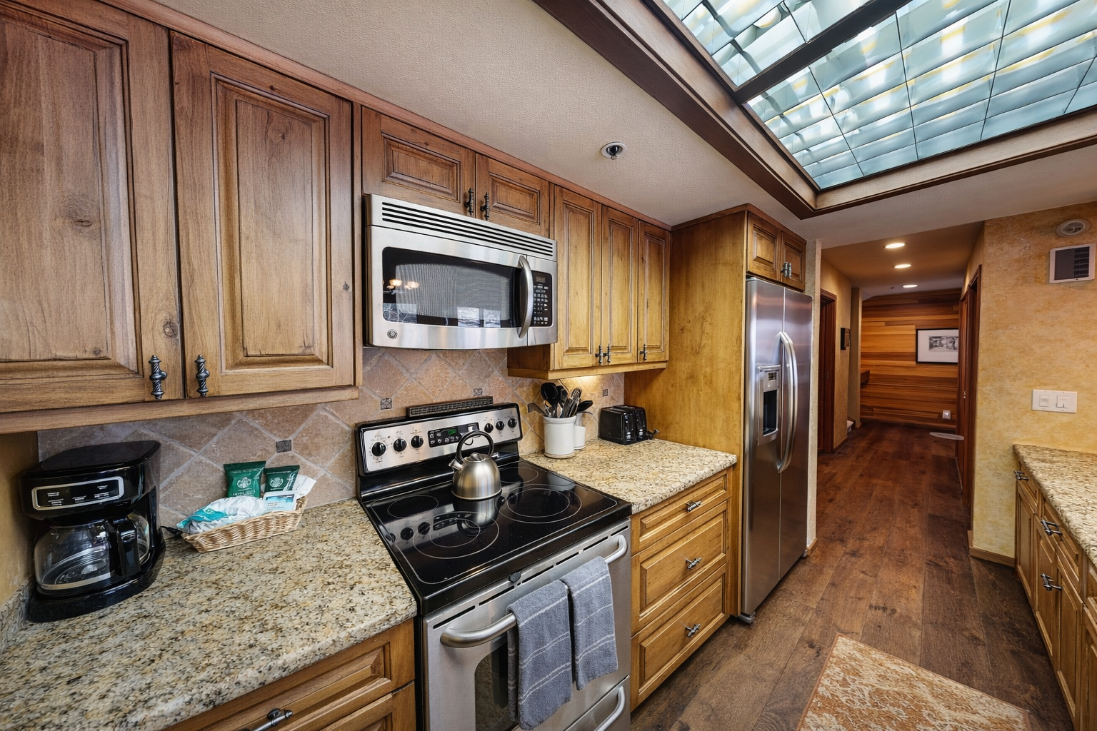 Whip up a fantastic feast in our fully equipped chef's kitchen, featuring granite countertops, stainless steel appliances, and a skylight for natural light.