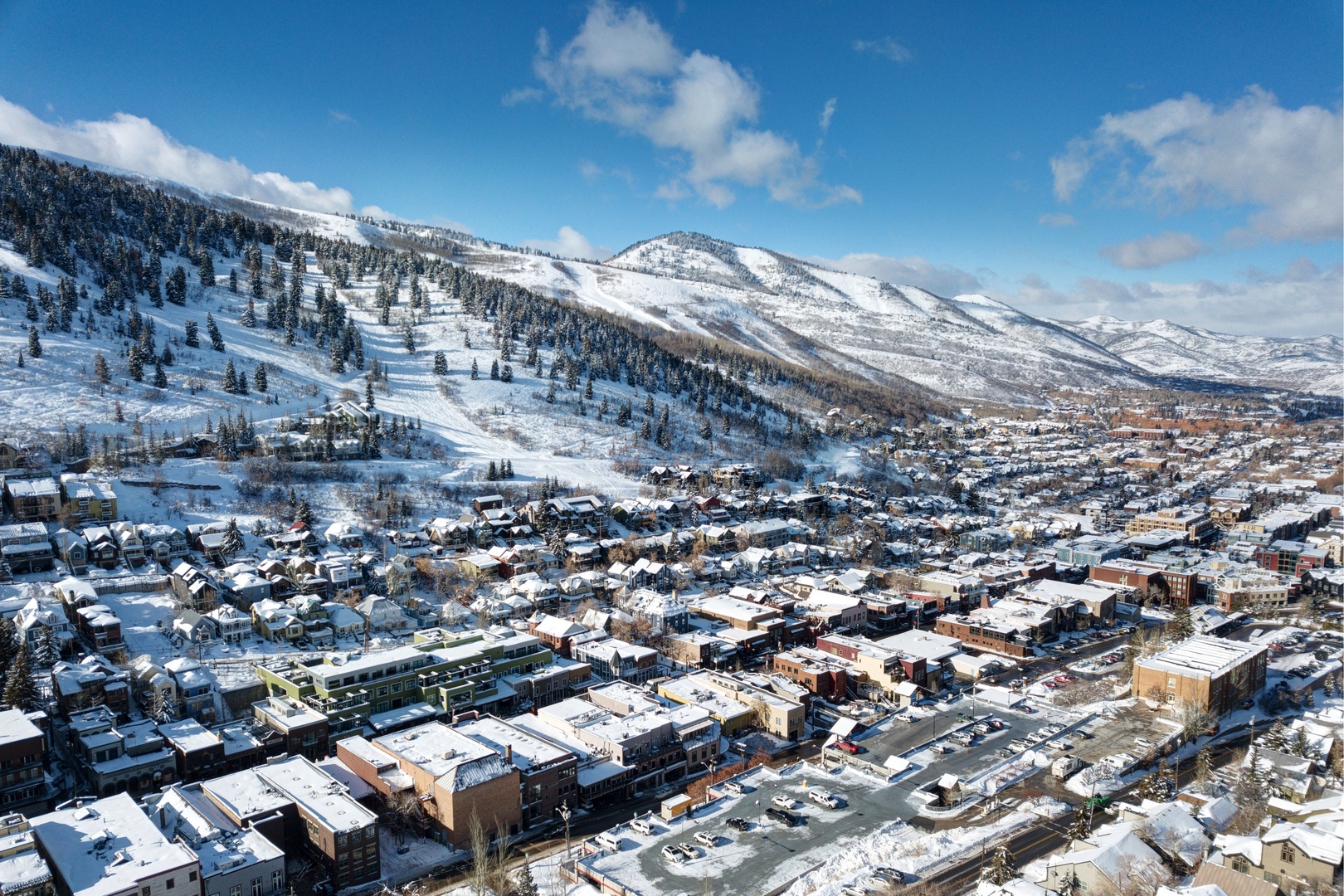 Stunning aerial view of a charming mountain town nestled in snow-covered peaks, perfect for winter adventures and scenic getaways.