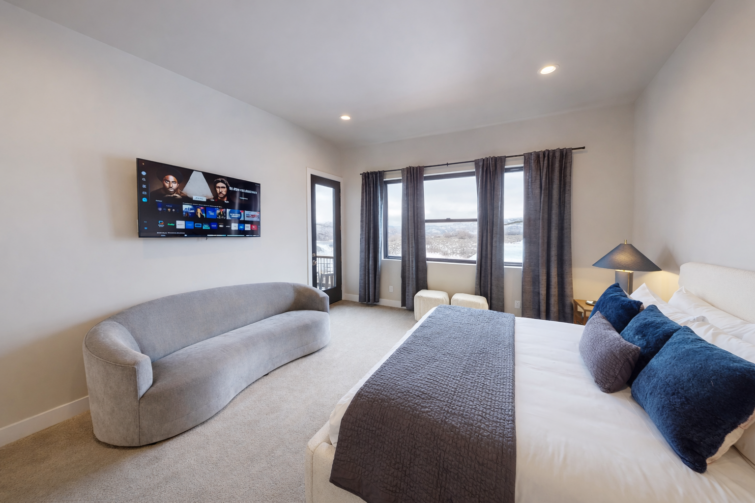 Sink into your plush bed and unwind with your favorite shows on the wall-mounted TV while enjoying mountain views through large windows.
