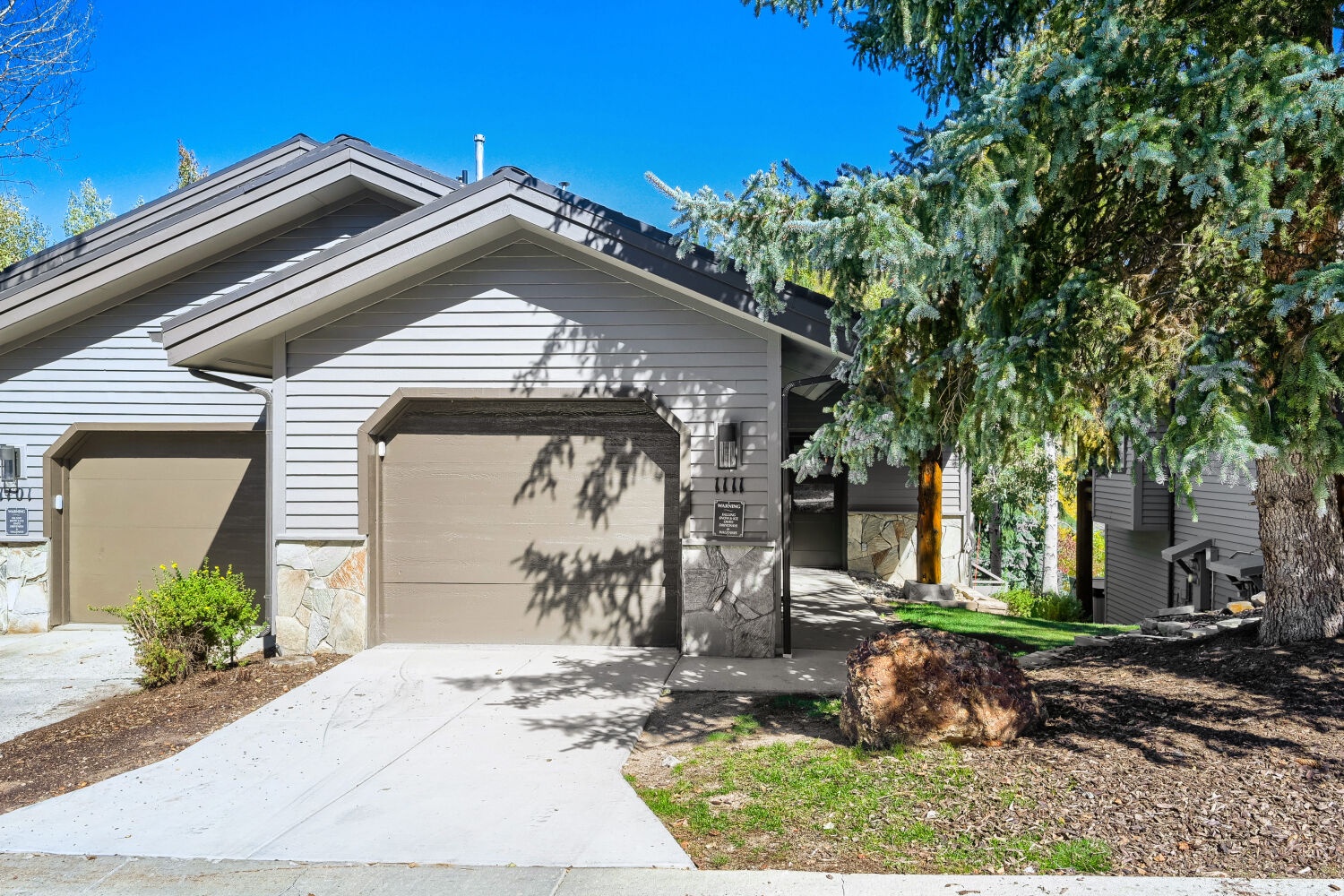 A welcoming two-story home set among mature evergreens and a peaceful residential setting, offering easy access to the surrounding mountain area.