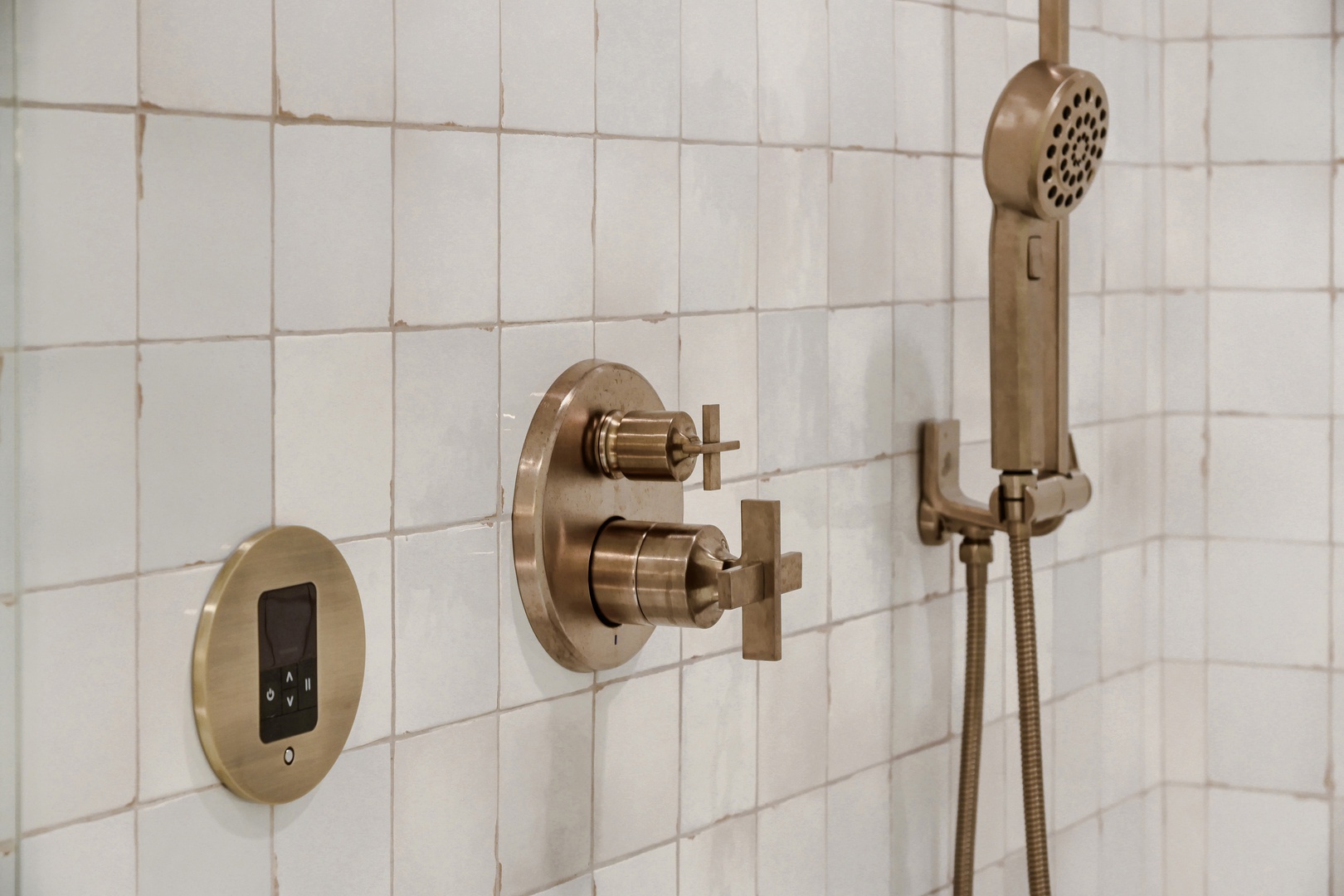Your private shower features elegant brass fixtures and a handheld sprayer, blending vintage charm with modern comfort for a refreshing rinse after every adventure.