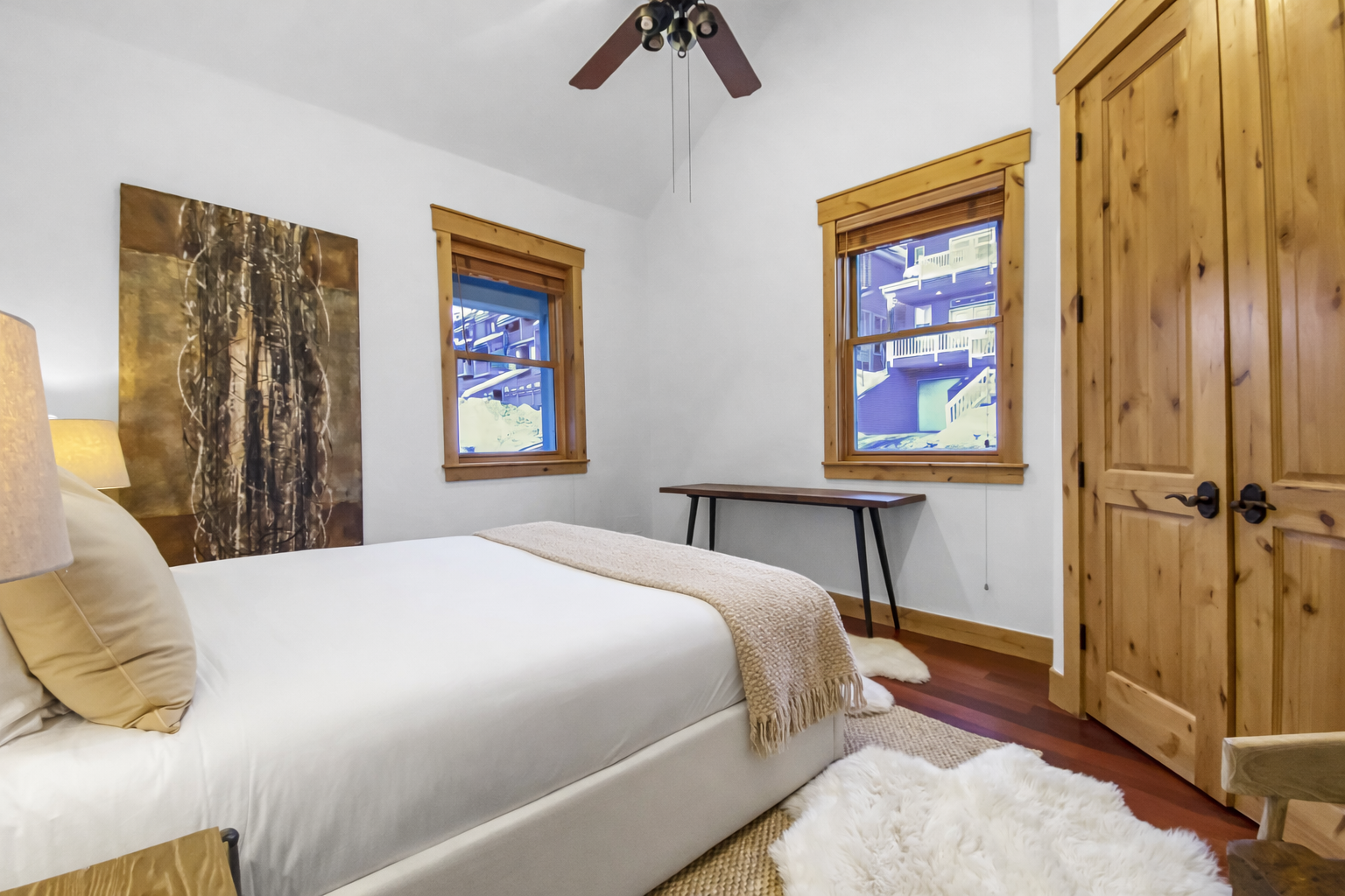 Wake to Alpine views from your cozy bedroom, where rustic wood touches meet plush comfort and warm natural light fills the space.